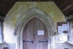 Blackmore - St Laurence - North door  Stone arch c.1400. Tacky elf n safety notice c. 2013. : Church, Essex, Door